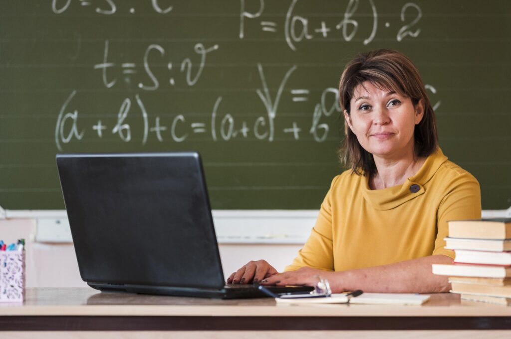 female-teacher-with-laptop-working